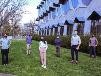 Samsara-funded research team stand outside socially distanced in masks.